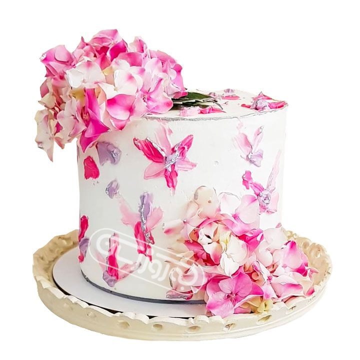 کیک گرد با تزیین گل های صورتی و سفید ادریسی شیرین کده یاس 